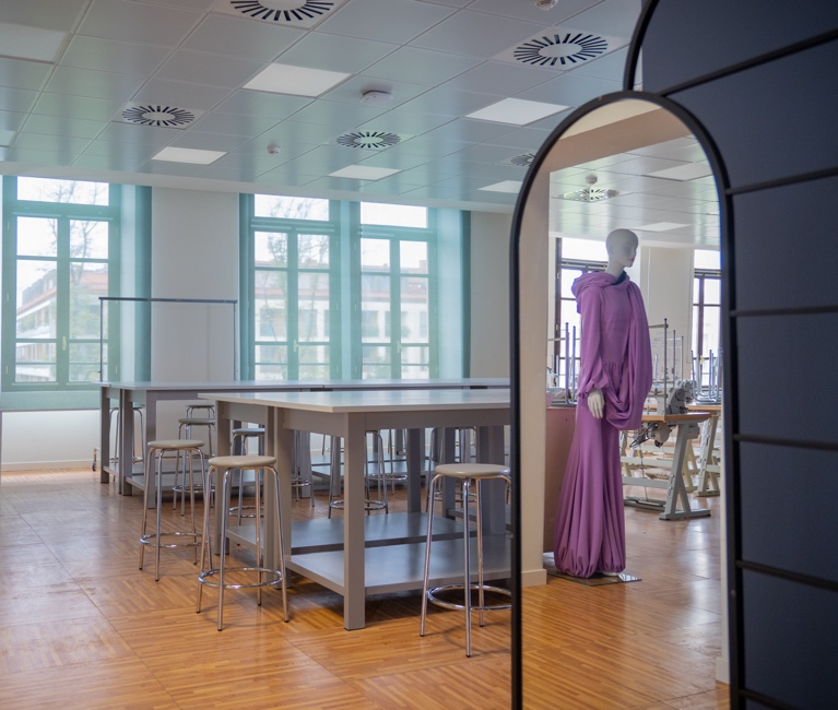 A classroom for fashion or textile design, showing a manikin on the right.
